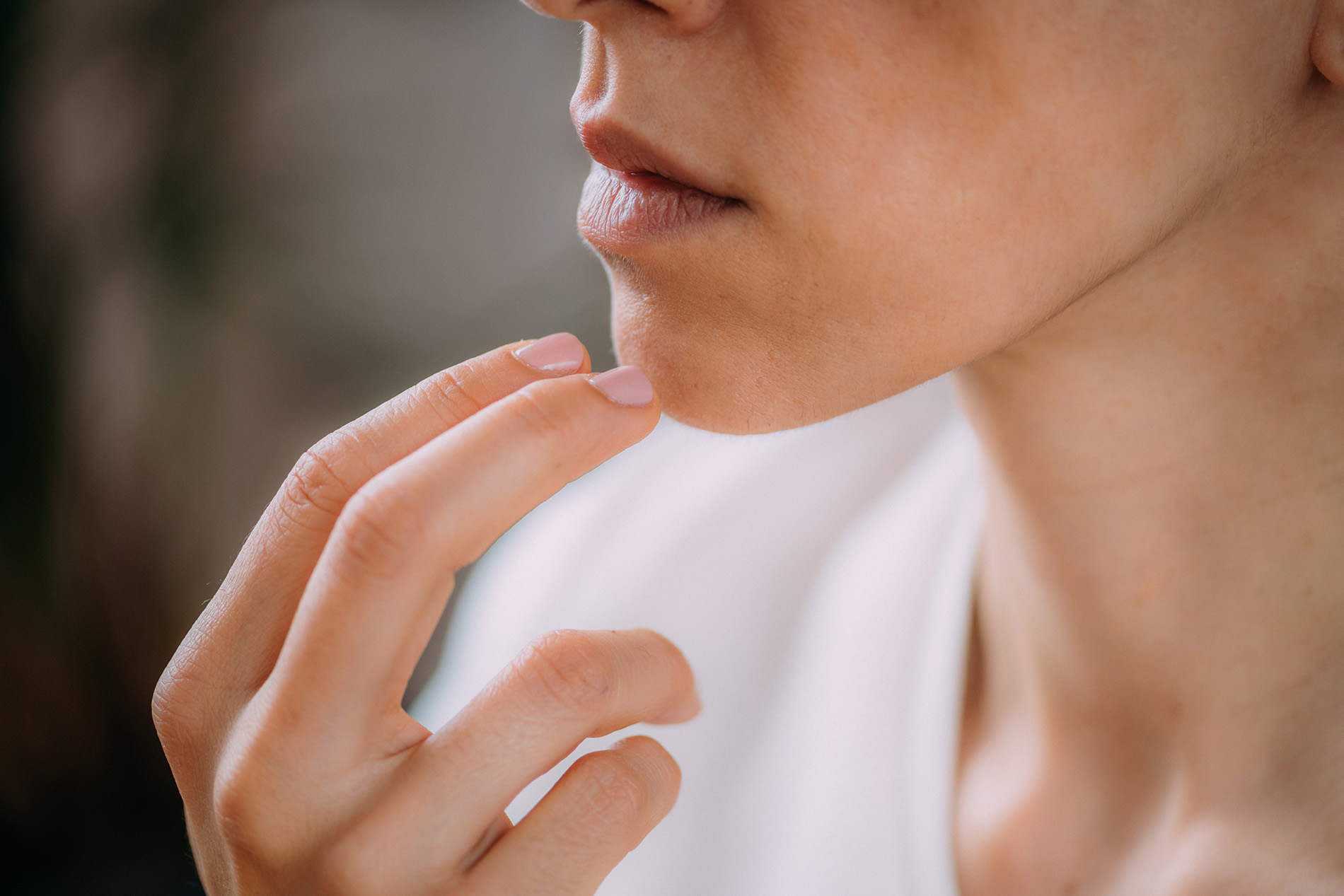 Woman practicing Tapping Therapy on her chin.